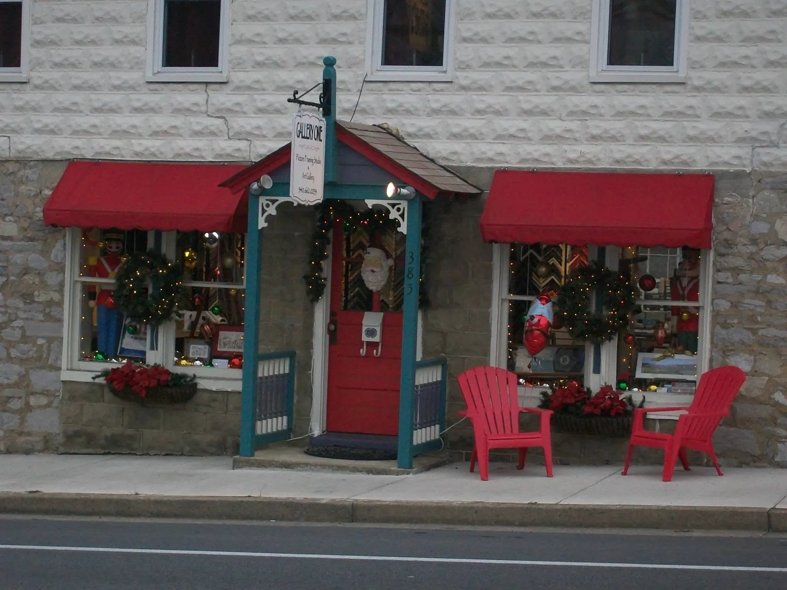 The Gallery One storefront on Millwood Avenue, with red awnings and a teal-trimmed door